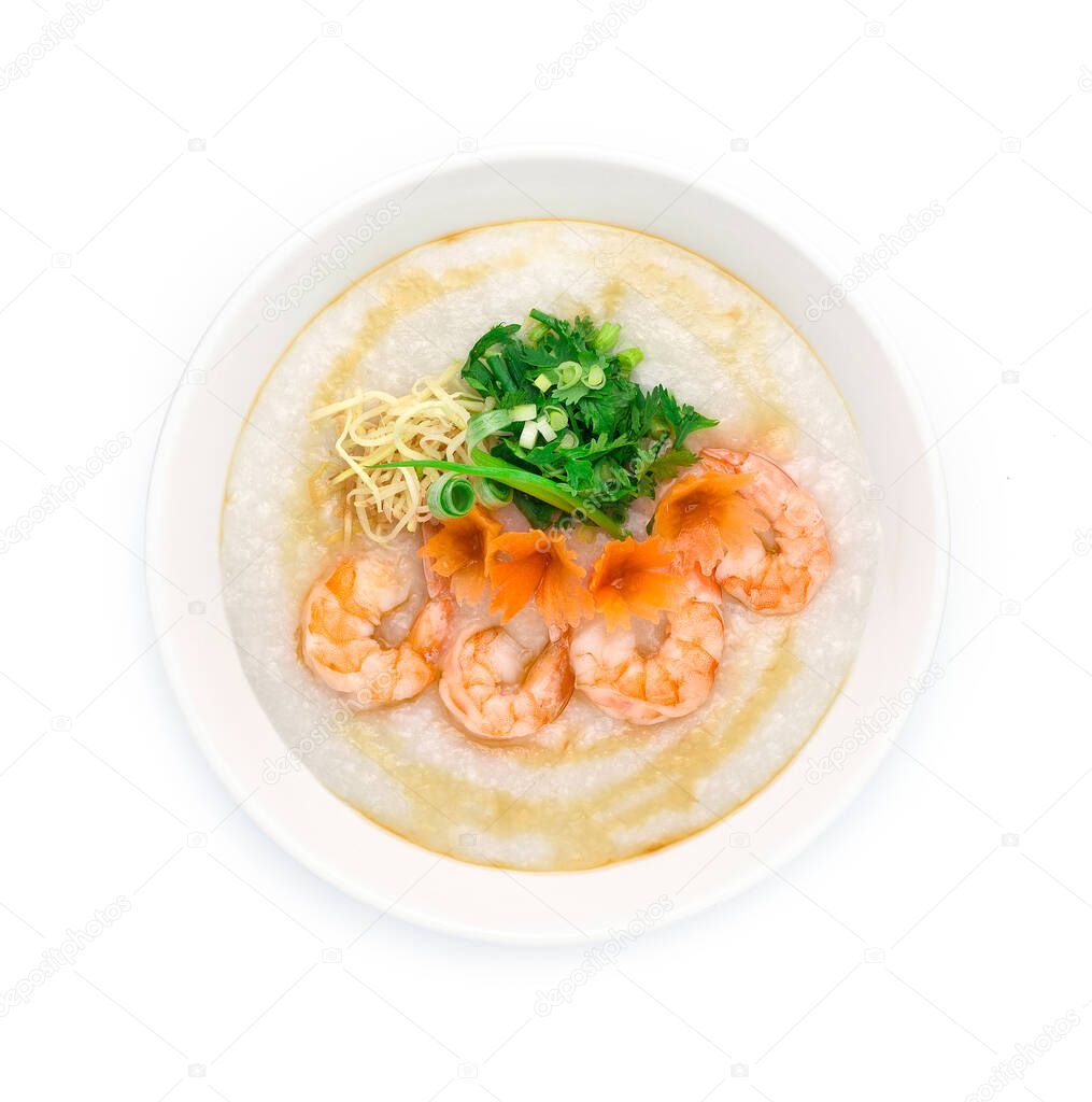 Congee Shrimps ,Rice Porridge served slice ginger and cutlet Celery,coriander thai herb. Asian Food breakfast decorate with carved carrots and spring onion top view