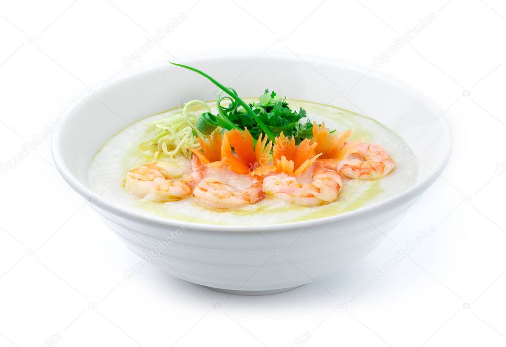 Congee Shrimps ,Rice Porridge served slice ginger and cutlet Celery,coriander thai herb. Asian Food breakfast decorate with carved carrots and spring onion side view