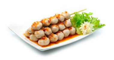 Bambu Çubuklu Domuz Topları, Tayland usulü tatlı biber sosu, Tayland usulü lezzetli yemek, Tayland sokak yemeklerinde meşhurdur, Asya Füzyonu, oyulmuş pırasa ve sebzelerle süslenmiştir.
