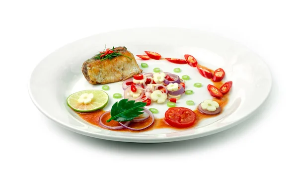 Spicy Mackerels Salad in Tomato sauce .Thai Food Cooking Decorate with leaf Kaffer,lime,onion,garlic,tomato,lemon grassand Red Chili side view isolated on white background