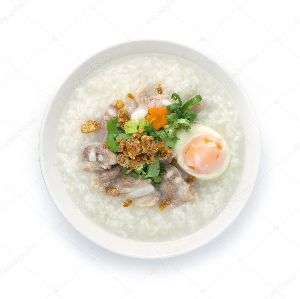 Rice Porridge with Pork Cartilage or Soft Spareribs Pork and Boiled Egg ontop spring onions,carrot and Celery cutlet is a classic Boiled Rice Food Asian breakfast dish made by boiling rice in a great deal of water