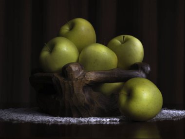 Siyah arka planda bir sepet yeşil elma.