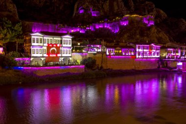 Amasya, Türkiye - Ağustos 2017: Eski Osmanlı evleri ve Amasya 'daki Yesilirmak Nehri' nin yansımalı manzaralı Saat Kulesi. Amasya Türkiye 'de daha popüler bir turizm beldesi.