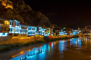 Amasya, Türkiye - Ağustos 2017: Eski Osmanlı evleri ve Amasya 'daki Yesilirmak Nehri' nin yansımalı manzaralı Saat Kulesi. Amasya Türkiye 'de daha popüler bir turizm beldesi.