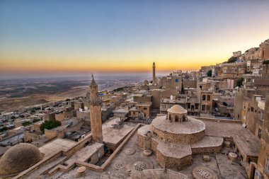 Mardin manzarası bulutlu Türkiye 'nin güzel günbatımı. Minareler Mardin 'in en iyi turistik beldesidir..