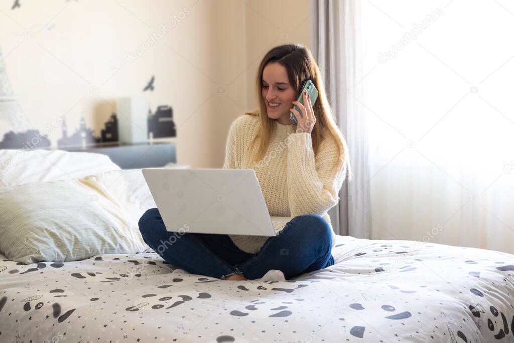 Photography of a woman teleworking in her bed from home talking on the phone. Coronavirus quarantine. Remote working woman.