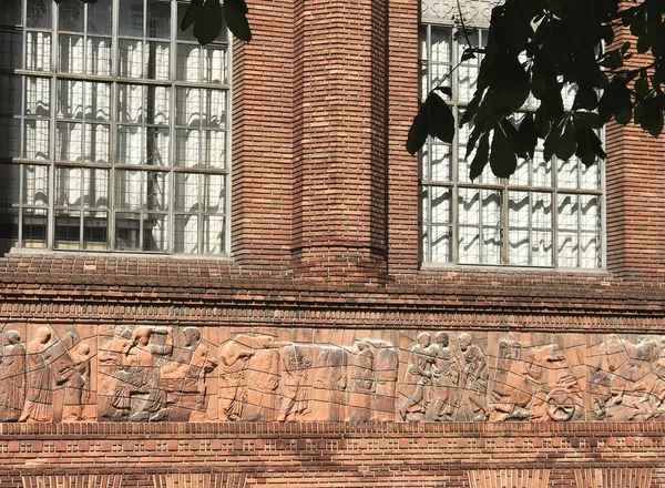 Fragment of brick wall with bas-relief and two windows with gratings — Stock Image Fragment Brick Wall Bas Relief Two Windows Gratings Royalty Free Stock Photos