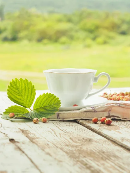 White cup of tea on a wooden table — Stock Photo, Image
