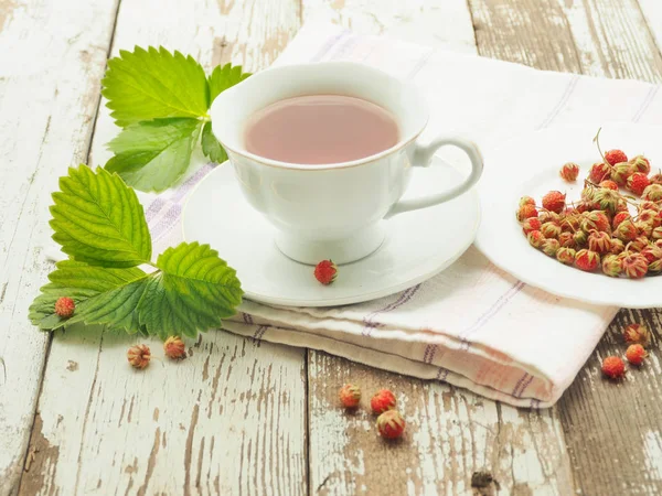 White cup of tea on a wooden table — Stock Photo, Image