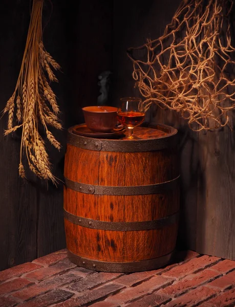Glas cognac met vat in gezellige kelder — Stockfoto
