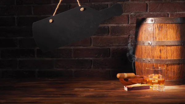 Glass of cognac with barrel on brick backgroun — Stock Photo, Image