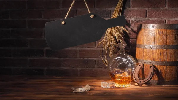 Glass of cognac with barrel on brick backgroun — Stock Photo, Image