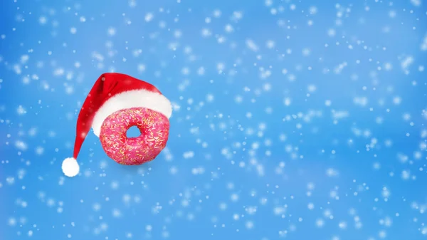 Sabroso donut con sombrero de Santa sobre fondo de nieve . —  Fotos de Stock