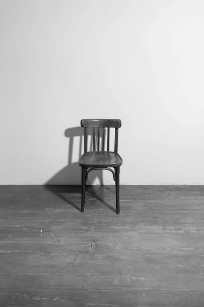 Old wooden chair in an empty room Stock Photo