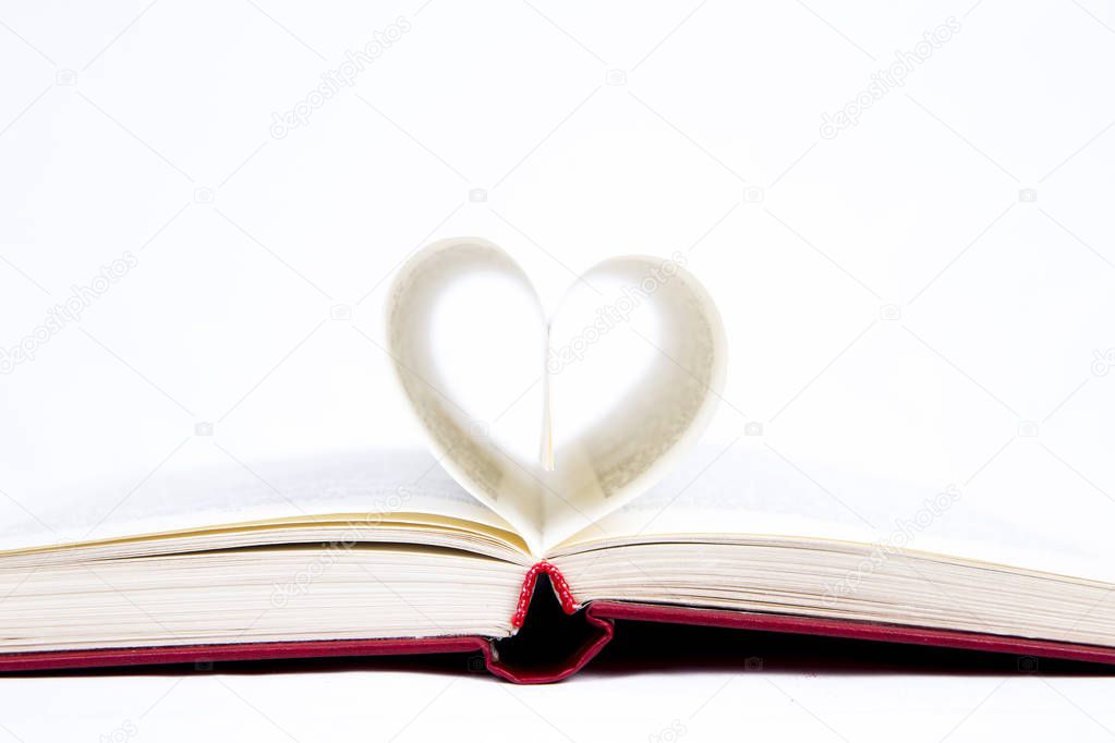 open book with sheets folded in the form of heart