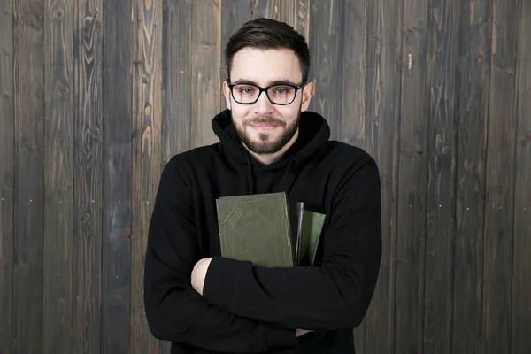 Attractive young man with a small beard in glasses and in black — Stock Photo, Image