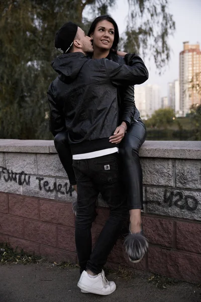 couple in love: a beautiful young girl in black clothes smiling