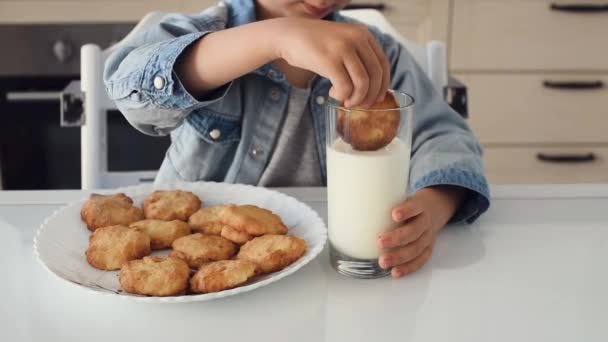 A kisfiú házi készítésű sütiket mártott friss tejbe. — Stock videók