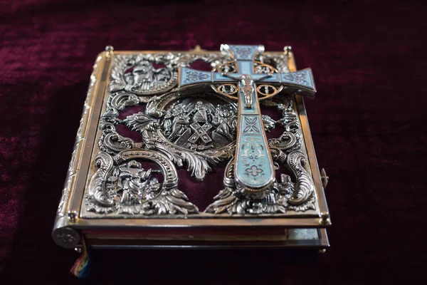 Bible with cross and wedding crowns