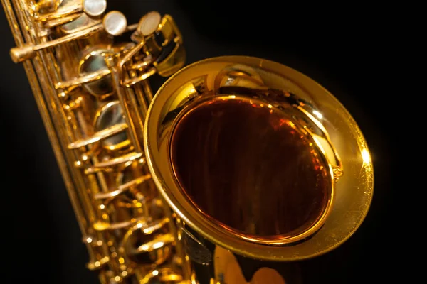 Golden saxophone on black background