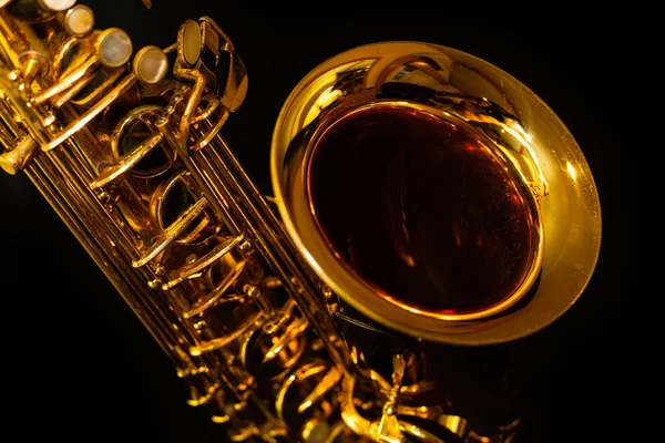 Golden saxophone on black background