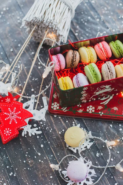 Christmas background with macaroons garlands and snow