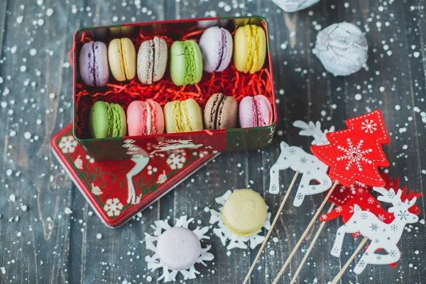 Christmas background with macaroons garlands and snow