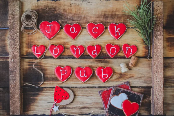 Red heart cookies on wooden background Valentines day