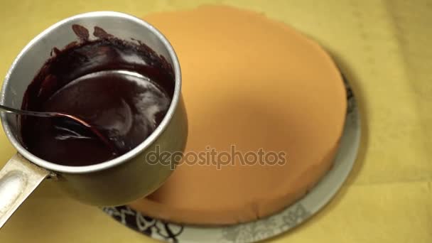 Mezclar glaseado de chocolate en una cacerola pequeña — Vídeo de stock