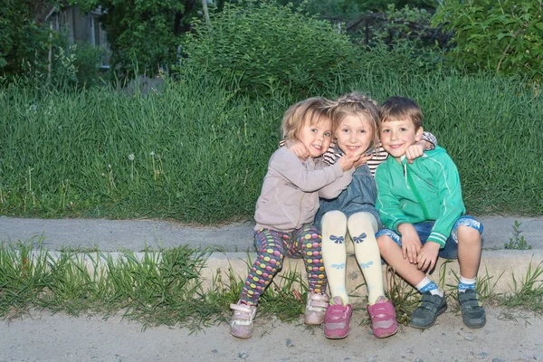 Portrait of children sitting on the curb — Stock Photo, Image