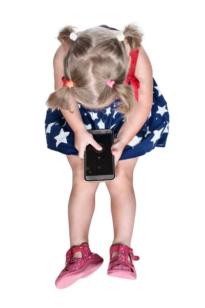 Little girl is playing on a smartphone — Stock Photo, Image