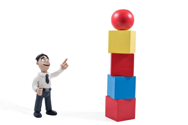Plasticine businessman points to the tower — Stock Photo, Image