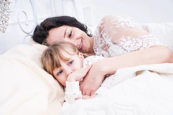 Mom with her daughter in bed