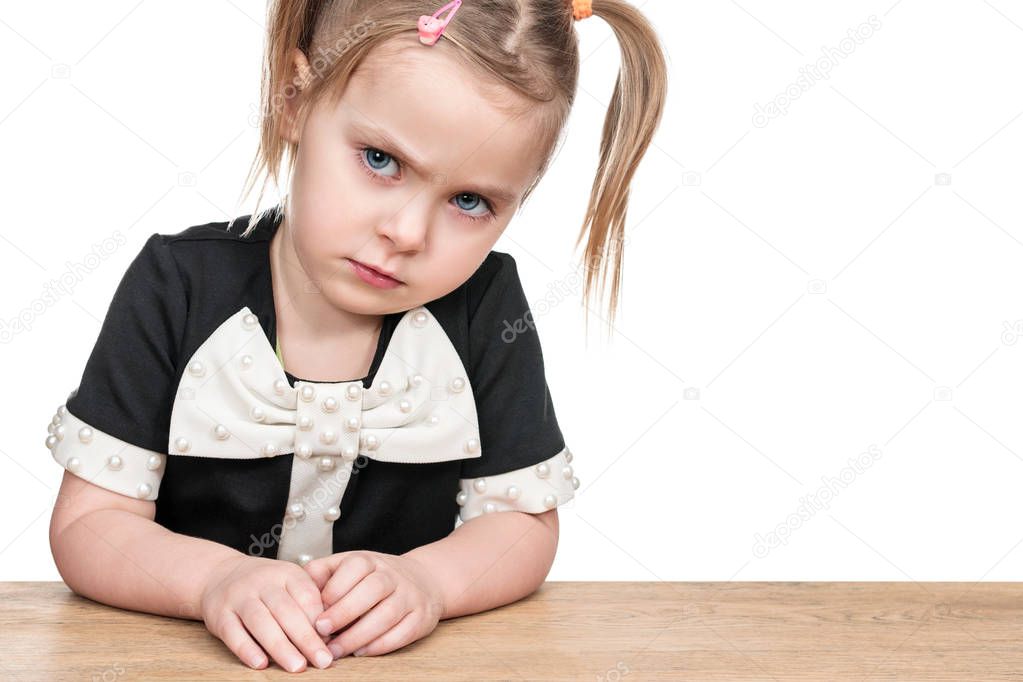 Portrait of serious child at a desk