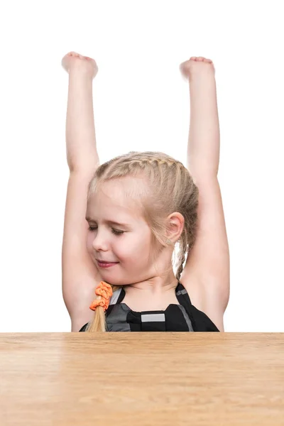 Girl stretches at the desk — Stock Photo, Image