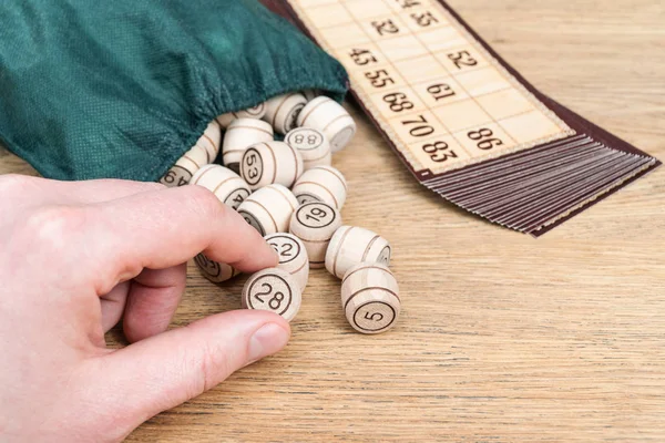 Hand with a keg lotto — Stock Photo, Image