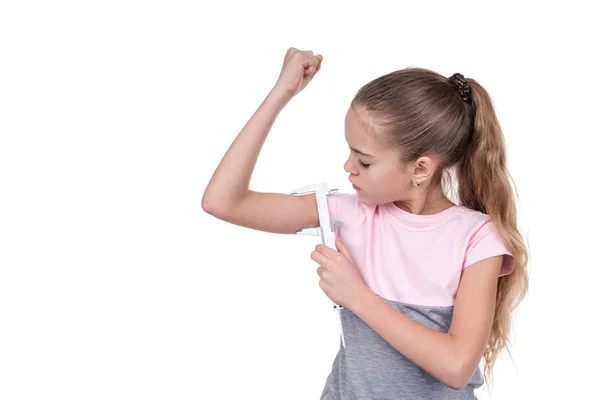 Girl measures the muscles with a caliper — Stock Photo, Image