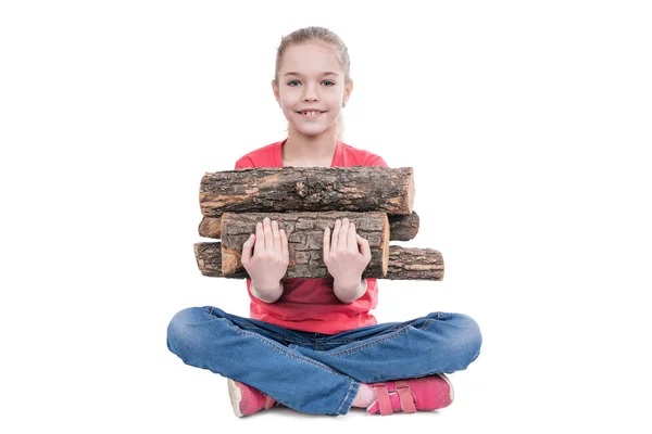 Girl with an armful of firewood — Stock Photo, Image