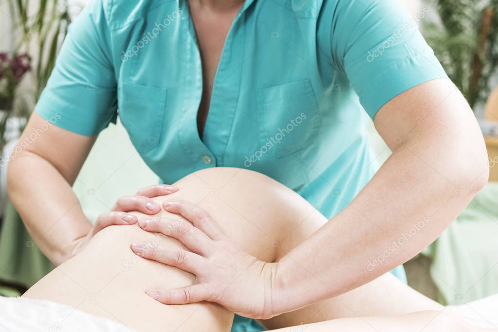 Doctor doing thigh massage