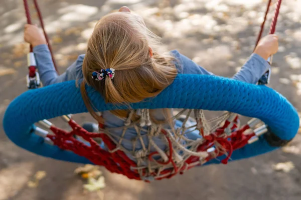 Girl riding a swing - basket — Stock Photo, Image