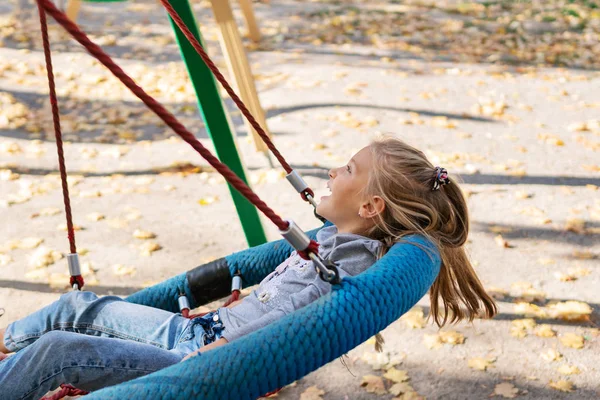 Child swinging on a swing — Stock Photo, Image