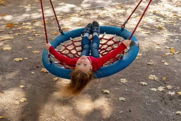 Girl riding a swing - basket — Stock Photo, Image