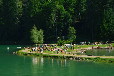 Montriond, Fransa - 8 Ağustos 2019. Montriond Gölü kıyısındaki insanlar, Portes du Soleil 'deki doğal göl, Haute-Savoie bölgesi, Fransa birçok turist için bir cazibe merkezi.. 