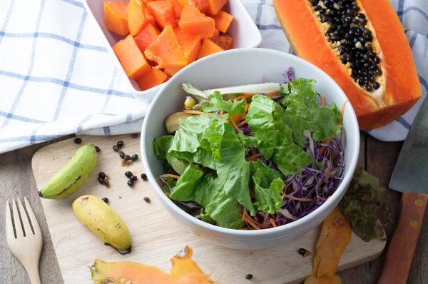 Mesa de cocina con ensalada de verduras en plato blanco y rebanadas de — Foto de Stock