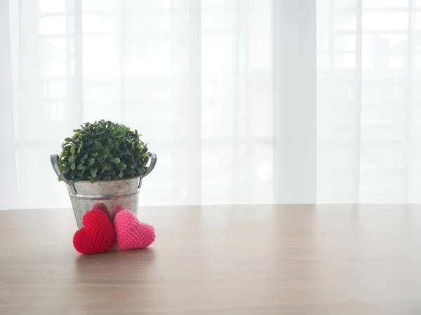 Wood office table with red heart shape sign and small garden tre — Stock Photo, Image