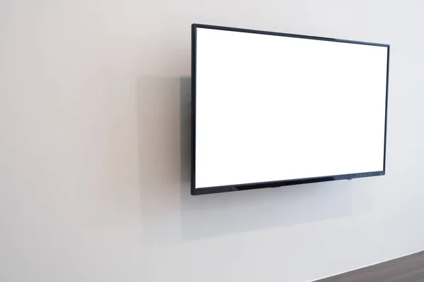blank screen television on concrete wall at living room. copy space for text on TV.