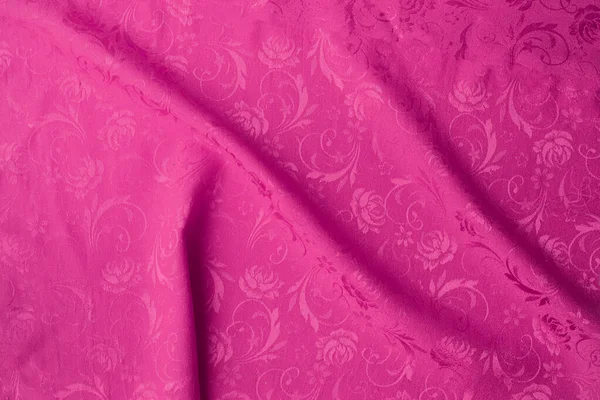 Pink Creased fabric texture background.