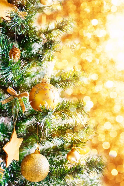 Christmas golden ornaments on tree closeup — Stock Photo, Image