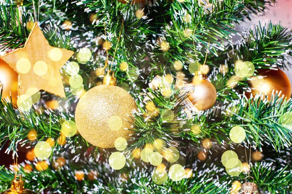Christmas golden ornaments on tree closeup — Stock Photo, Image