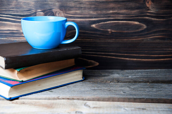 Hot coffee or tea, cocoa, chocolate cup on books